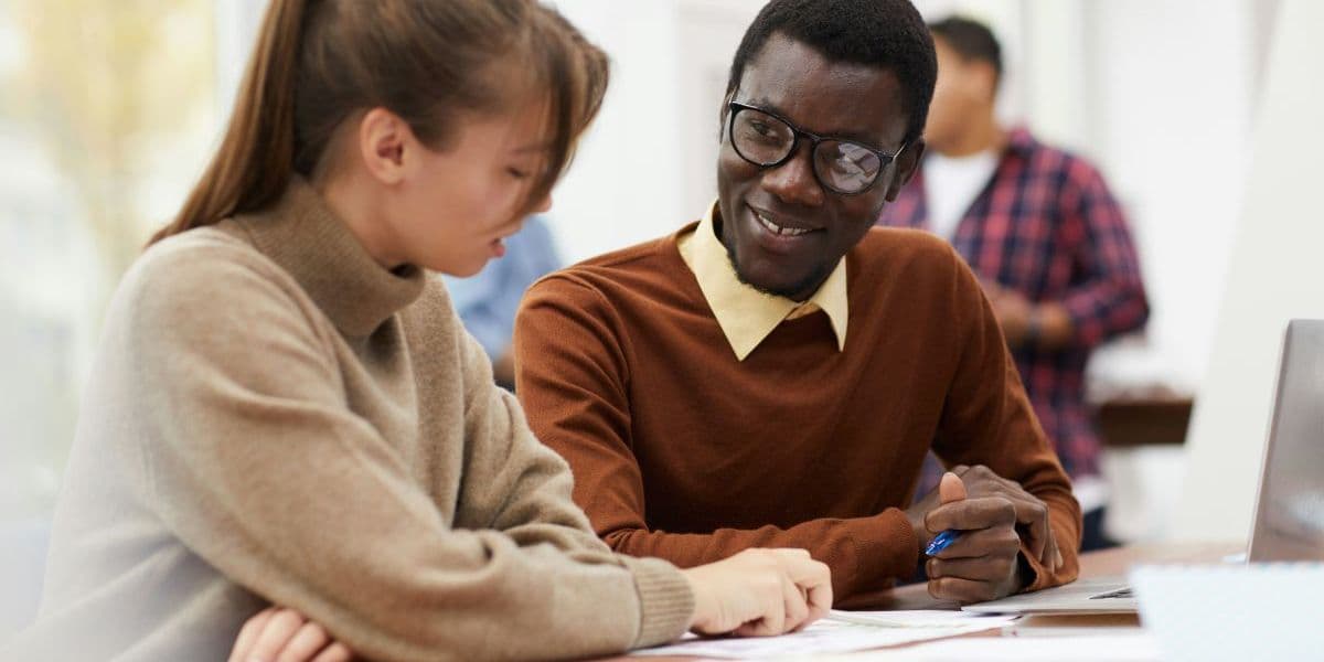 Student and instructor in a classroom during tech training.